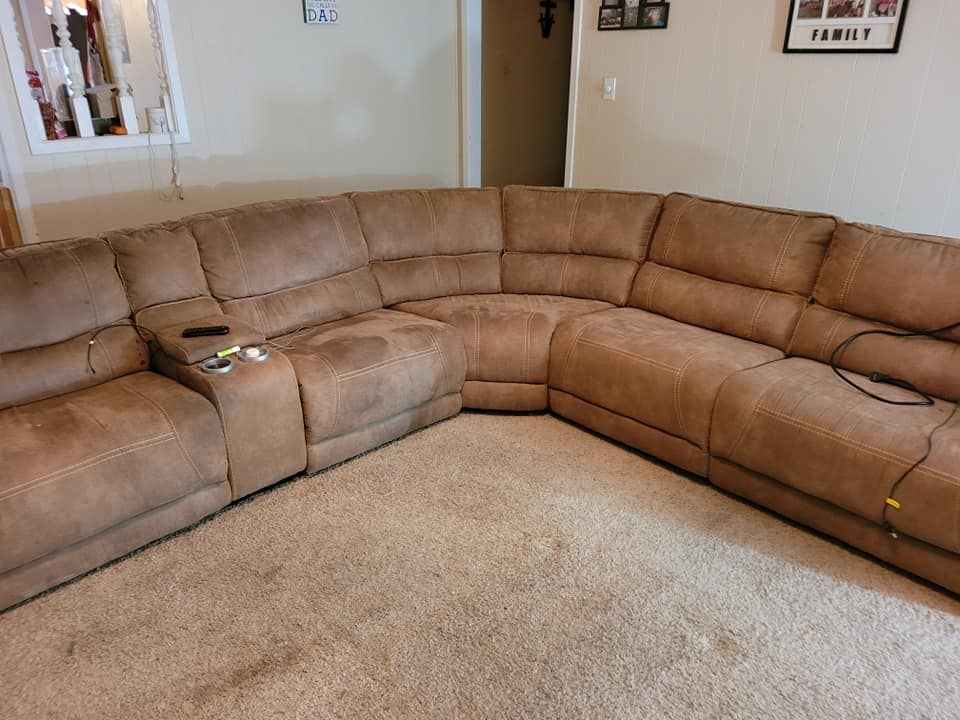 A large sectional couch is sitting in a living room.