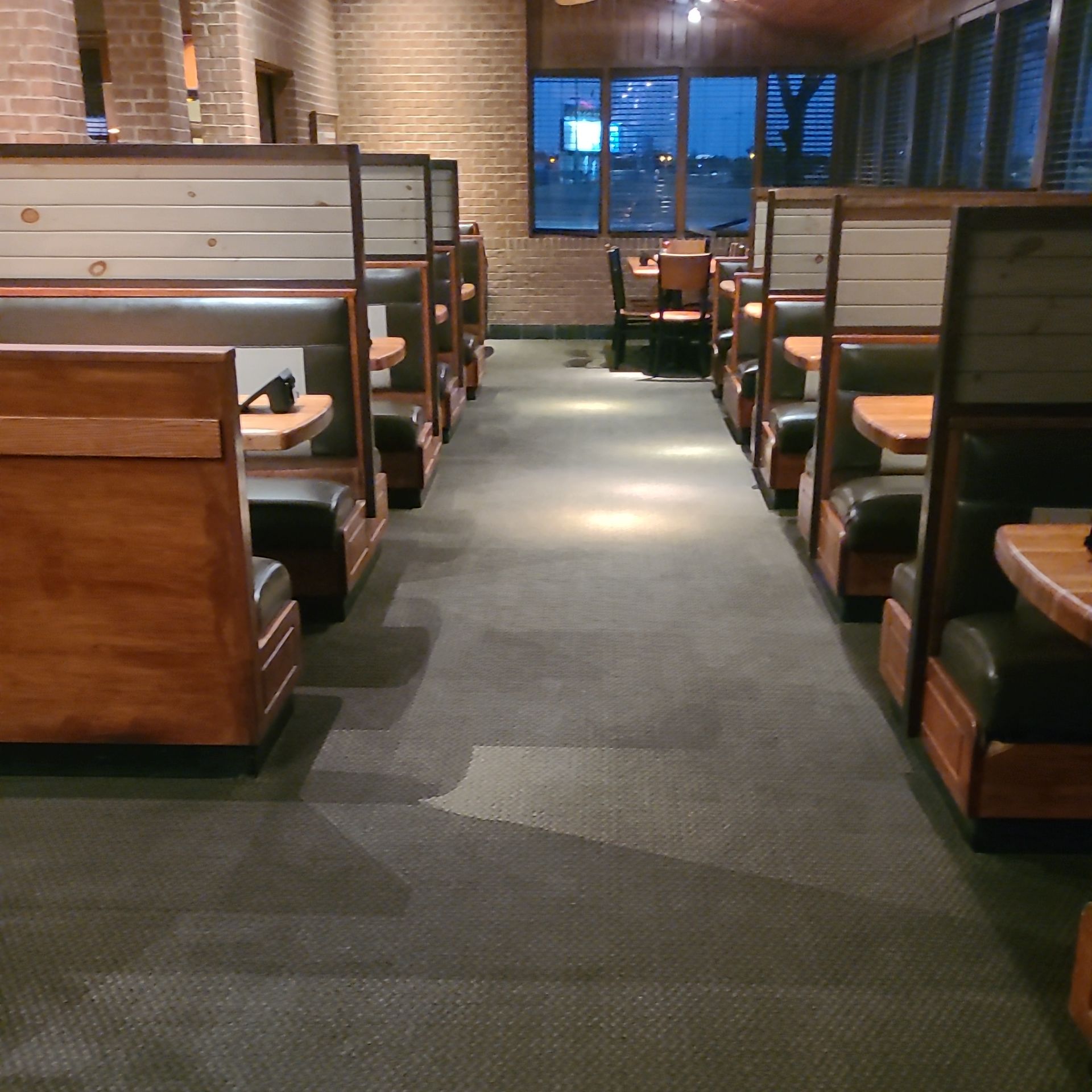 A restaurant with a lot of booths and tables