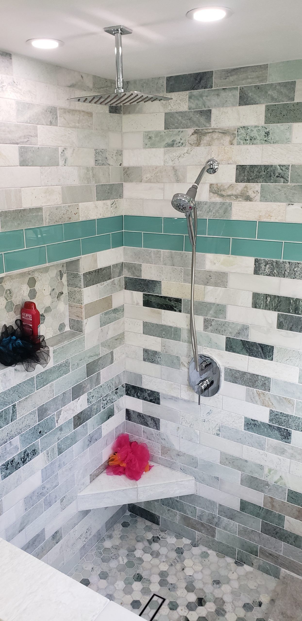 A bathroom with a sliding glass shower door from a Bathroom remodel in San Diego CA by Team  Renovate