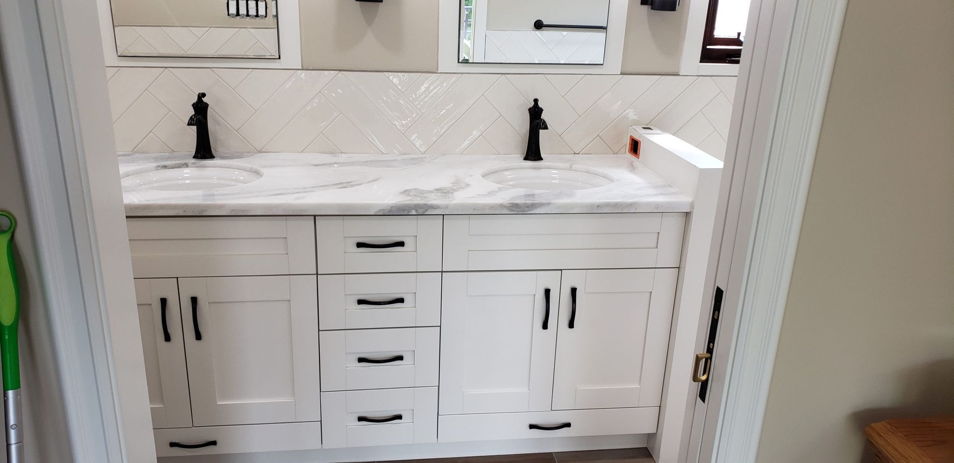 A bathroom with two sinks and a mirror.