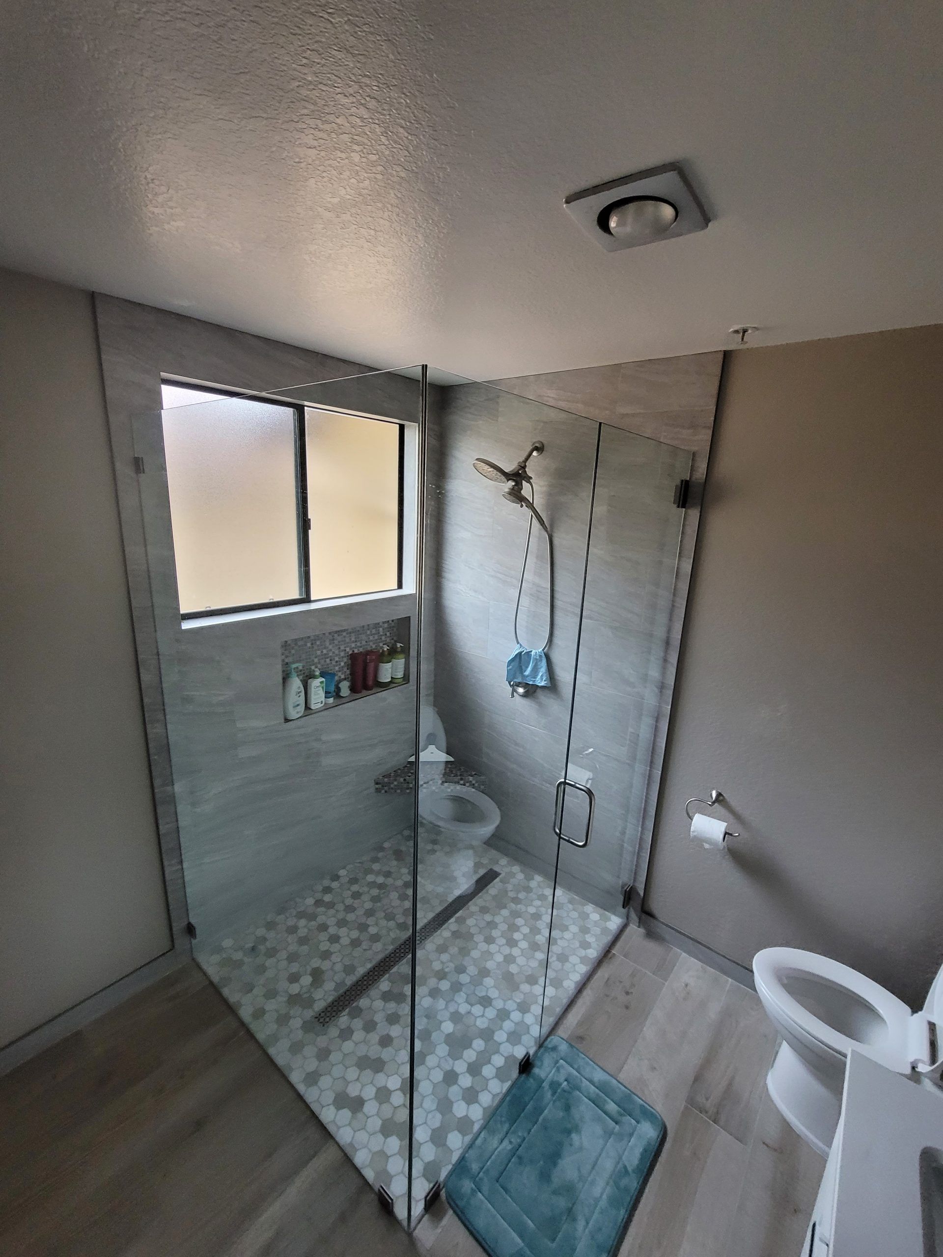 A bathroom with a walk in shower and a bathtub from a Bathroom remodel in San Diego CA by Team  Renovate