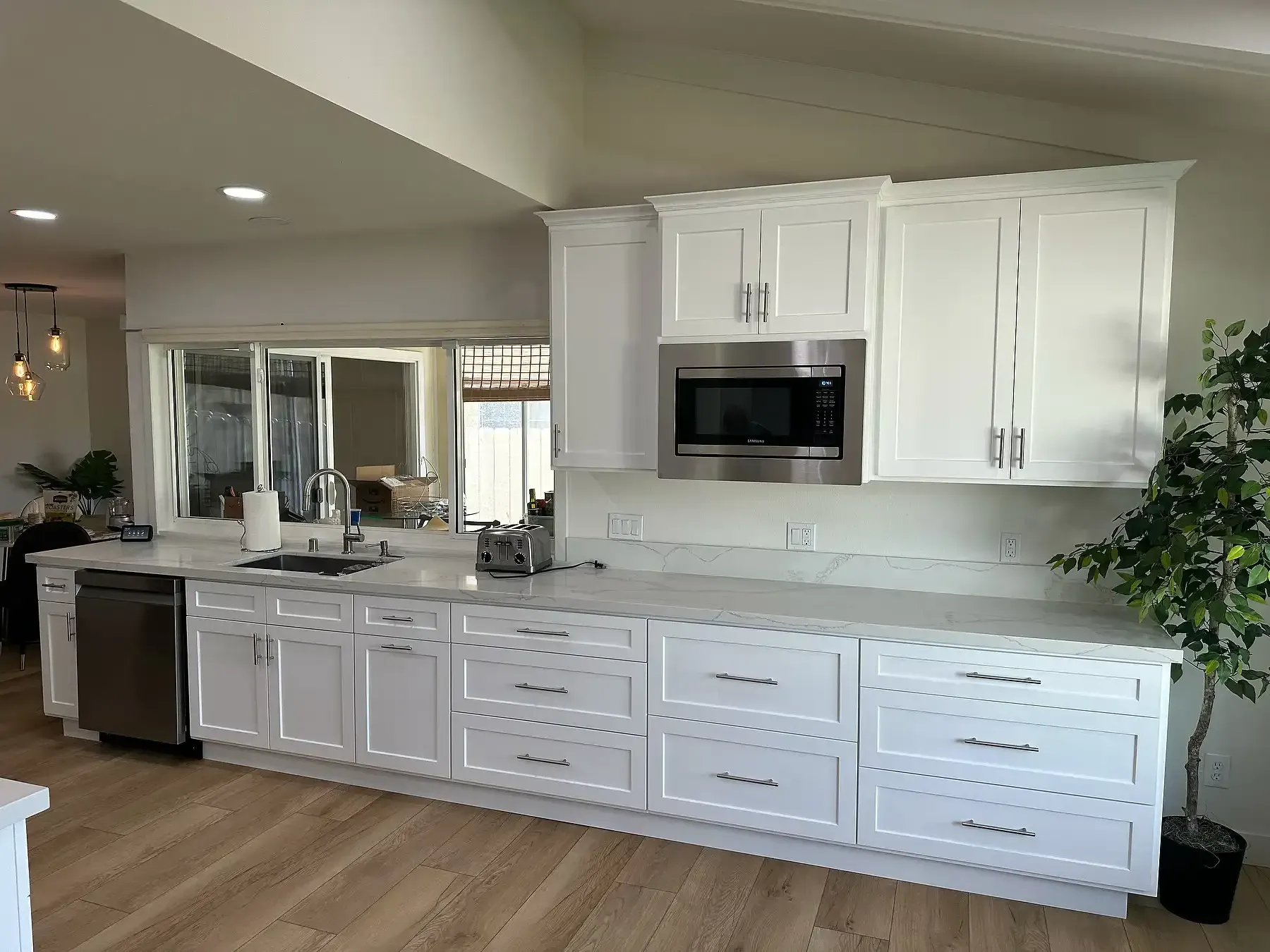 A kitchen with white cabinets and stainless steel appliances.