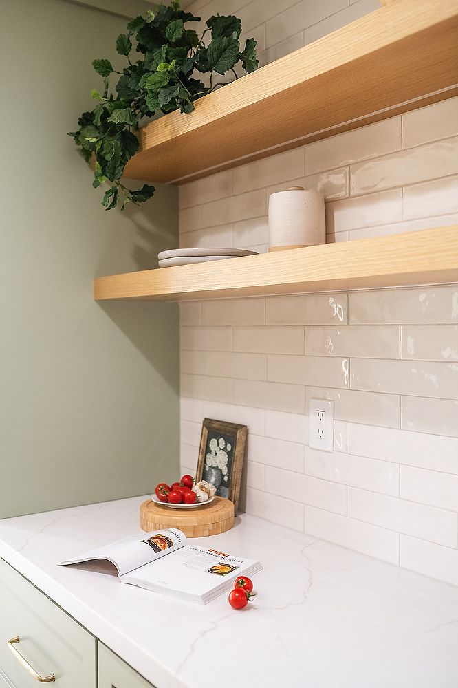 Full kitchen remodel in San Diego by Team Renovate . sage brush cabinets  floating shelves