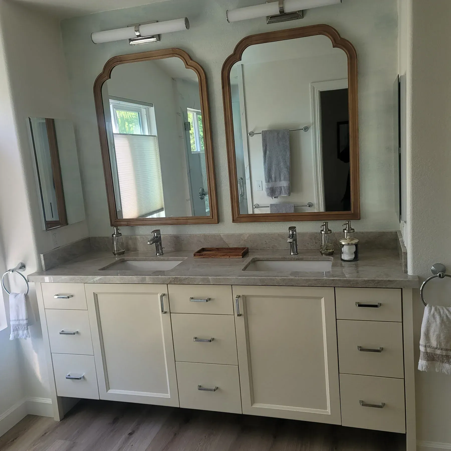 A bathroom with two sinks and two mirrors from a Bathroom remodel in San Diego CA by Team  Renovate