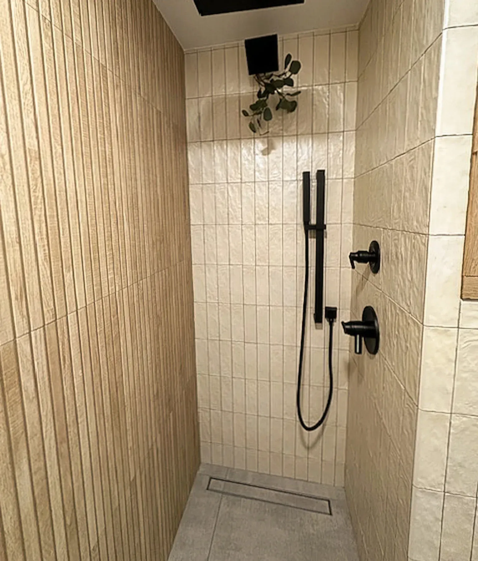 A bathroom with a walk in shower and a plant on the ceiling. from a Bathroom remodel in San Diego CA by Team  Renovate