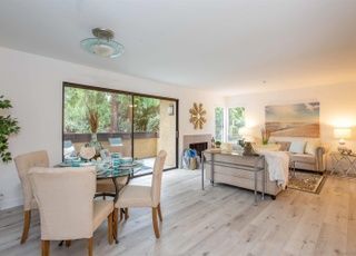A living room with a dining table and chairs and a couch.