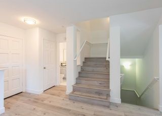 A hallway with stairs leading up to the second floor of a house.