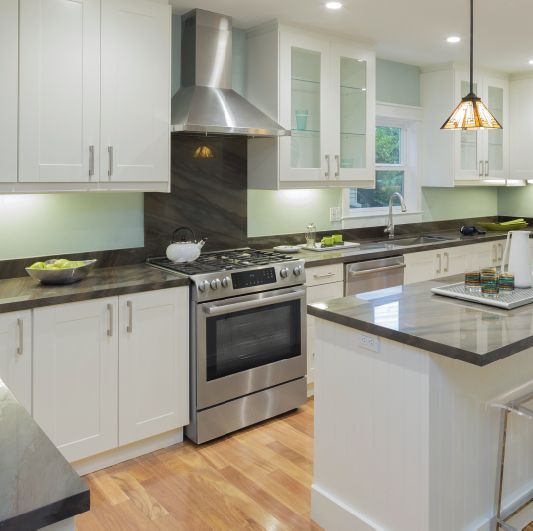 A kitchen with stainless steel appliances and white cabinets