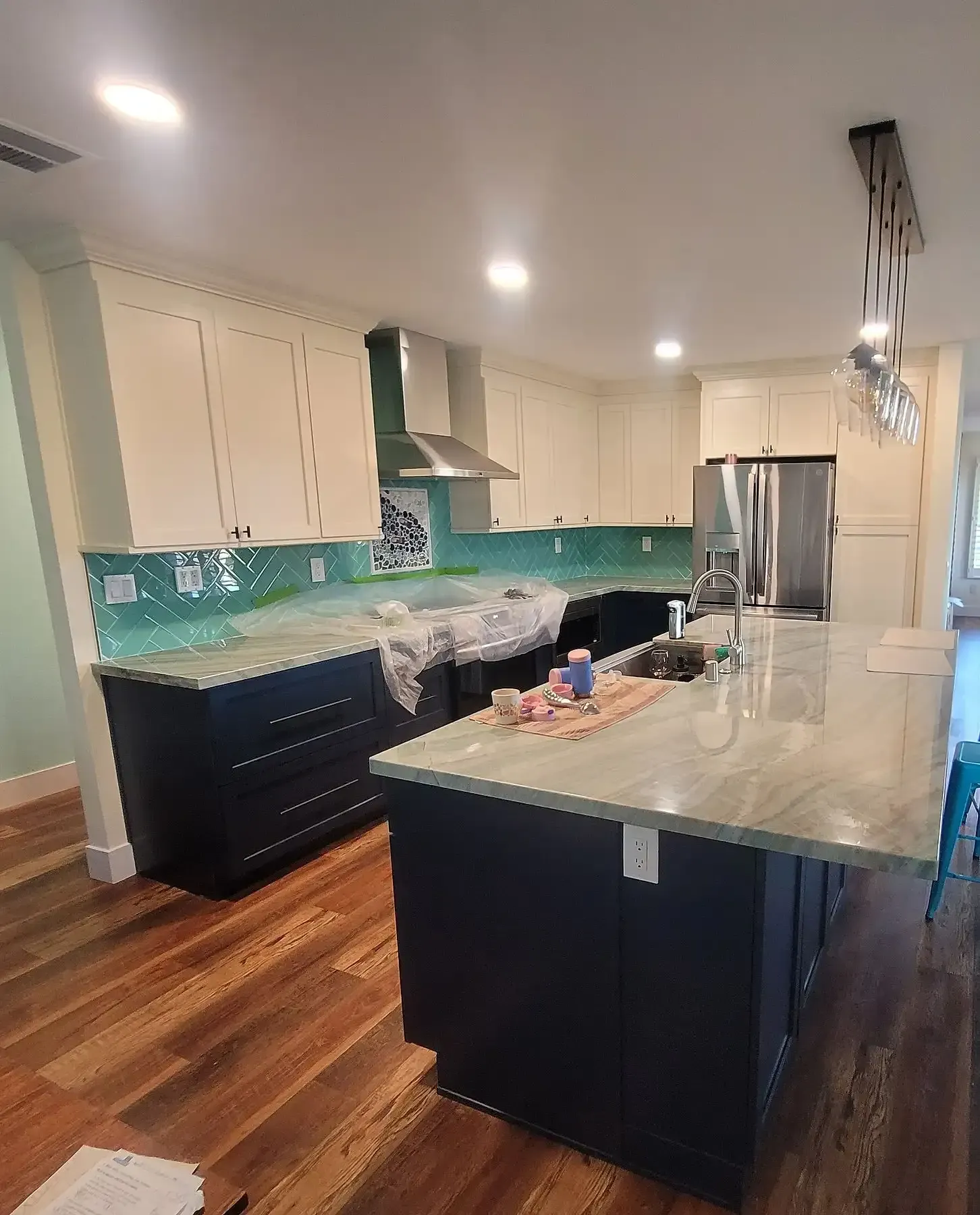 A kitchen with a large island and stainless steel appliances.