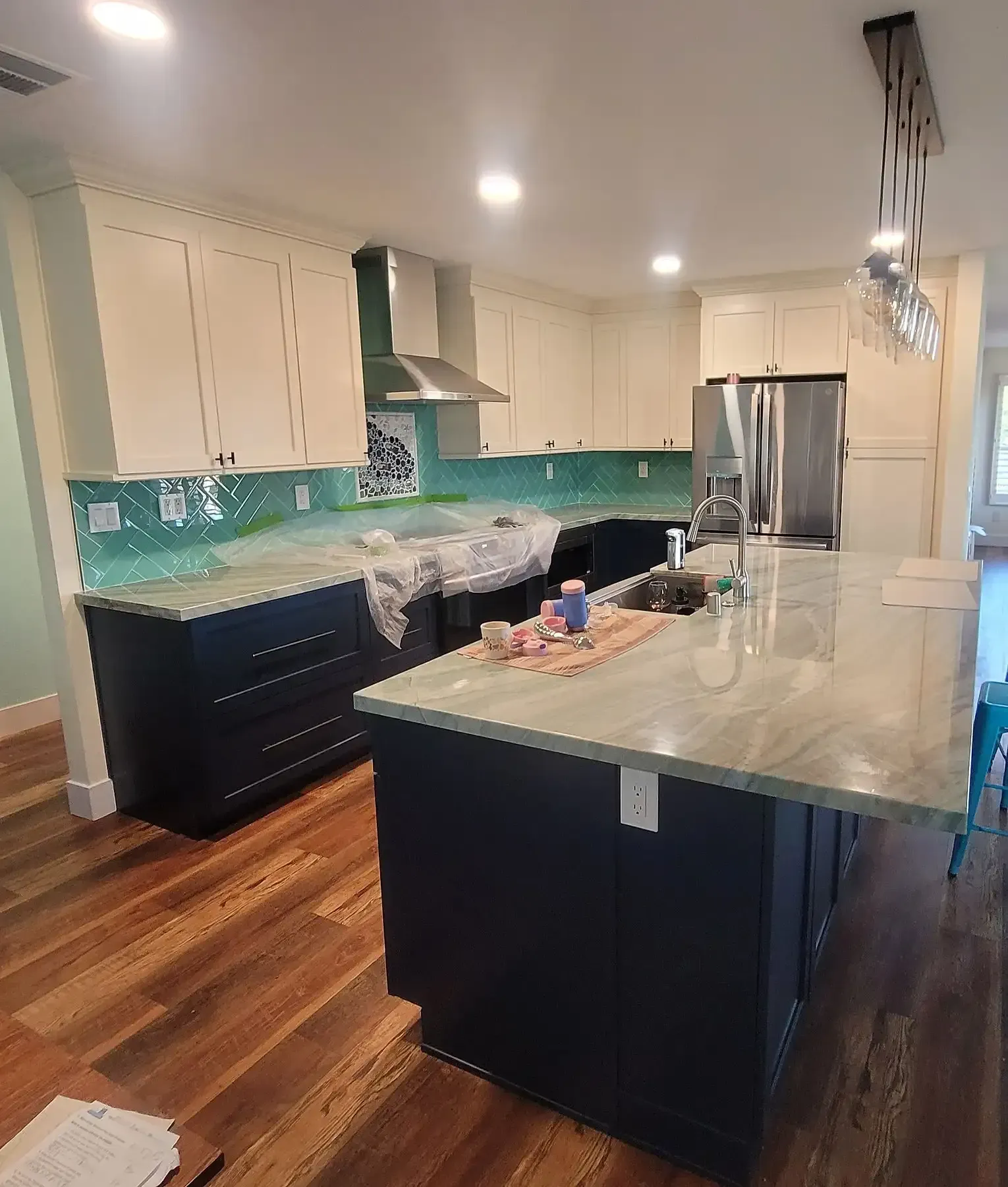 A kitchen with a large island and white cabinets