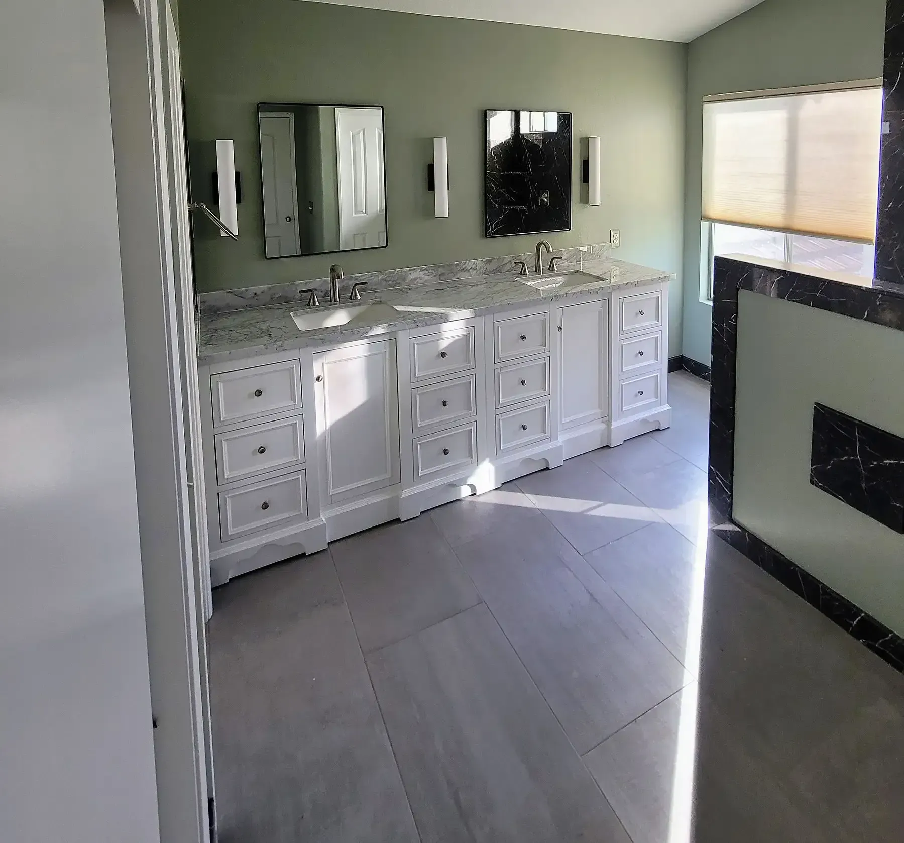 A bathroom with two sinks and two mirrors