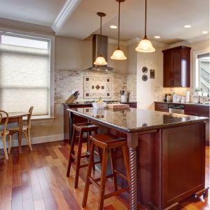 A kitchen with a large island and stools