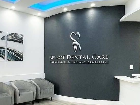 A waiting room with chairs and a sign that says select dental care.