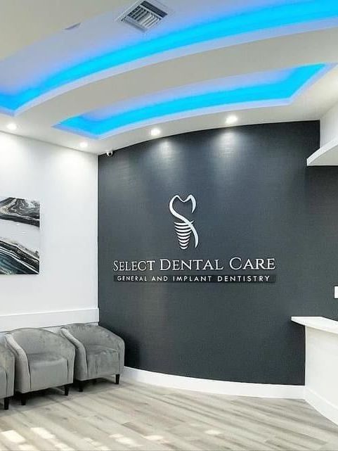 A dental office with a blue ceiling and a sign on the wall.