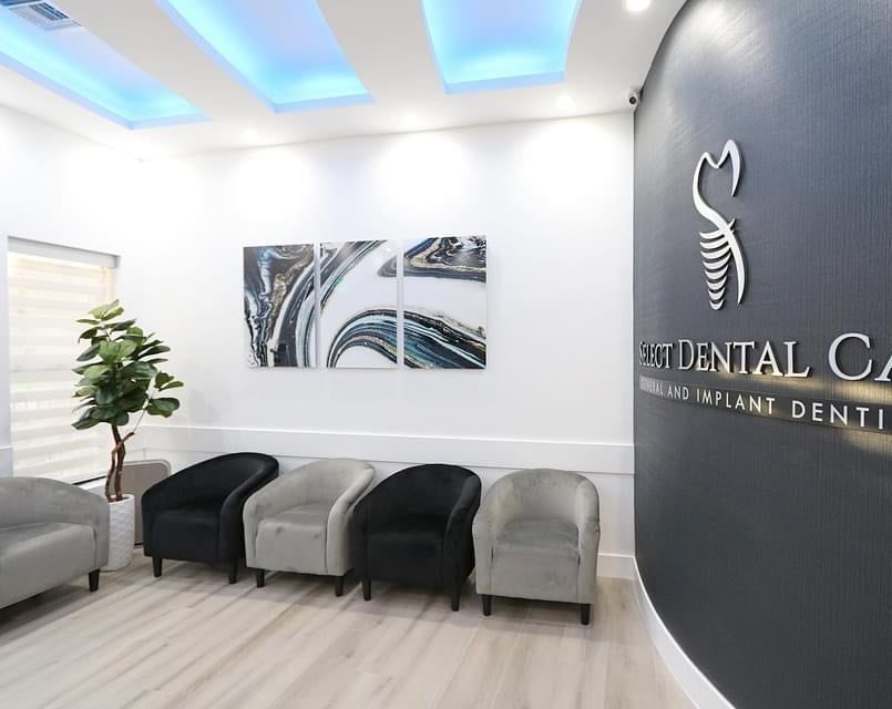 A waiting room with chairs and a sign that says dental care