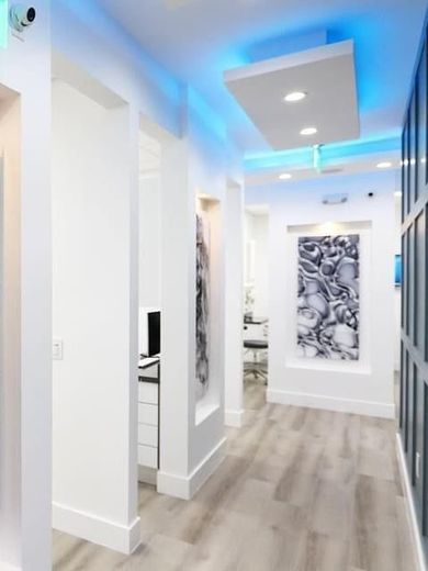 A hallway in a building with blue lights on the ceiling