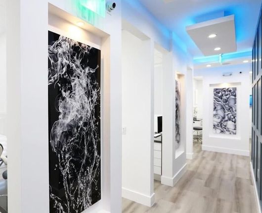 A hallway with a large black and white painting on the wall