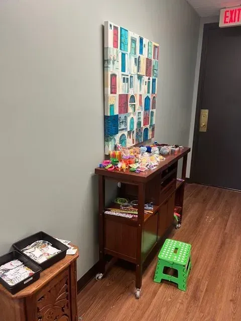 BBHC Facility's arts and crafts area with a table covered in creative projects.