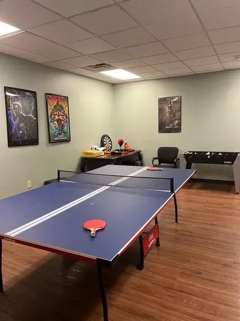 BBHC Facility's common area with a ping pong table, creating a lively and engaging environment.