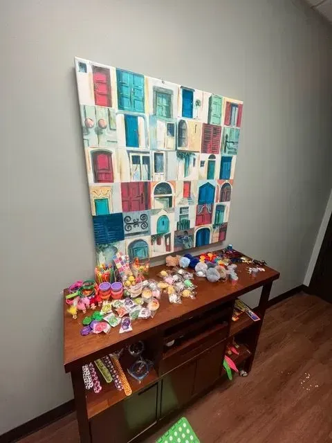 Table in BBHC Facility displaying various colorful crafts created by children