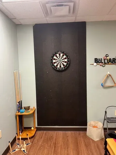 Recreational area at BBHC Facility with a dartboard behind the door for fun activities.