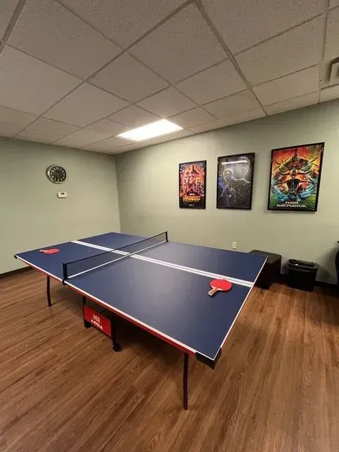 BBHC Facility's game room with a ping pong table, providing a fun and active pastime.