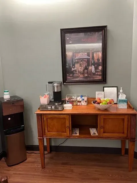 Close-up of a pantry with various snacks and supplies neatly arranged on a table at BBHC Facility.