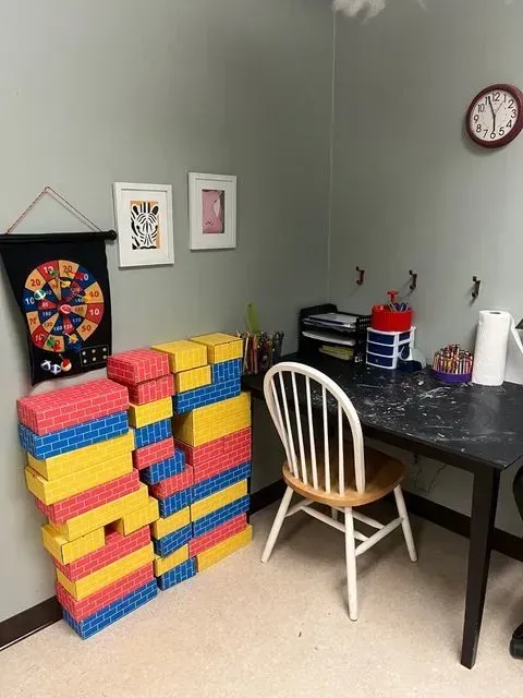 Table and chairs set up for children to engage in activities at BBHC Facility.