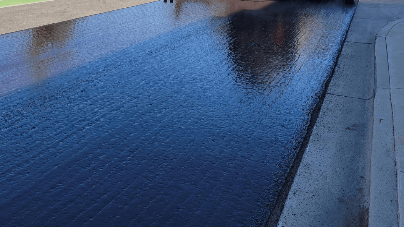 a shiny sealcoated asphalt path