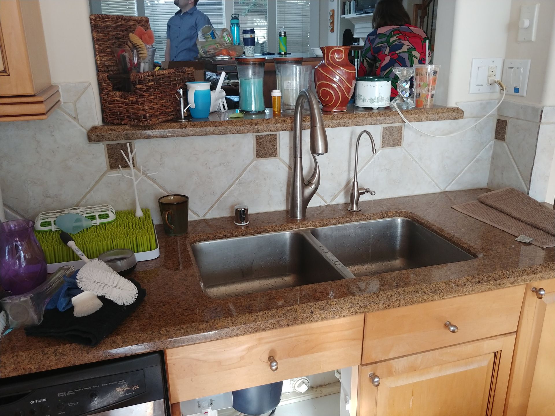 RO faucet installed on kitchen sink countertop with properly mounted air-gap device.