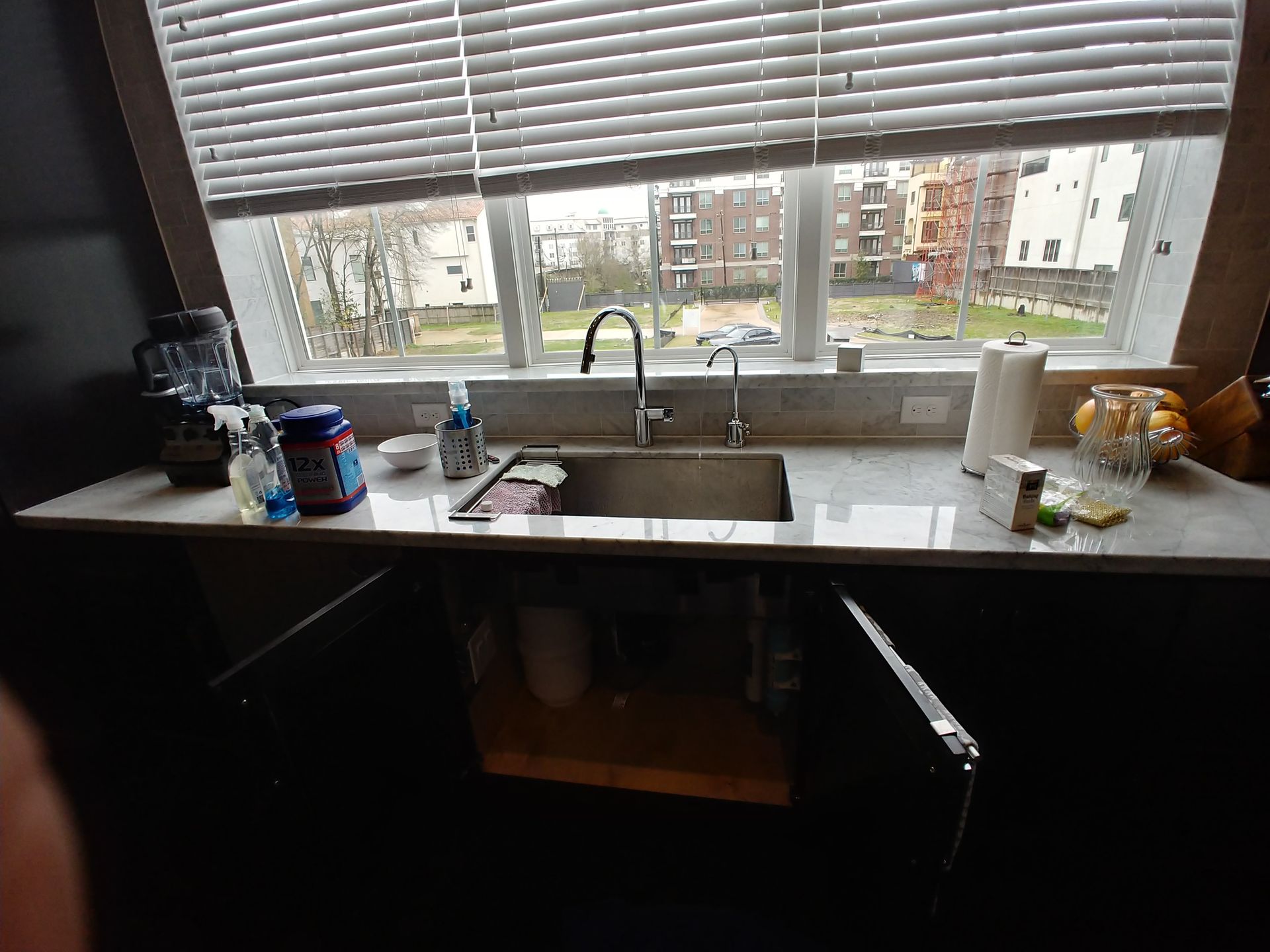 RO faucet installed on kitchen sink countertop with properly mounted air-gap device.