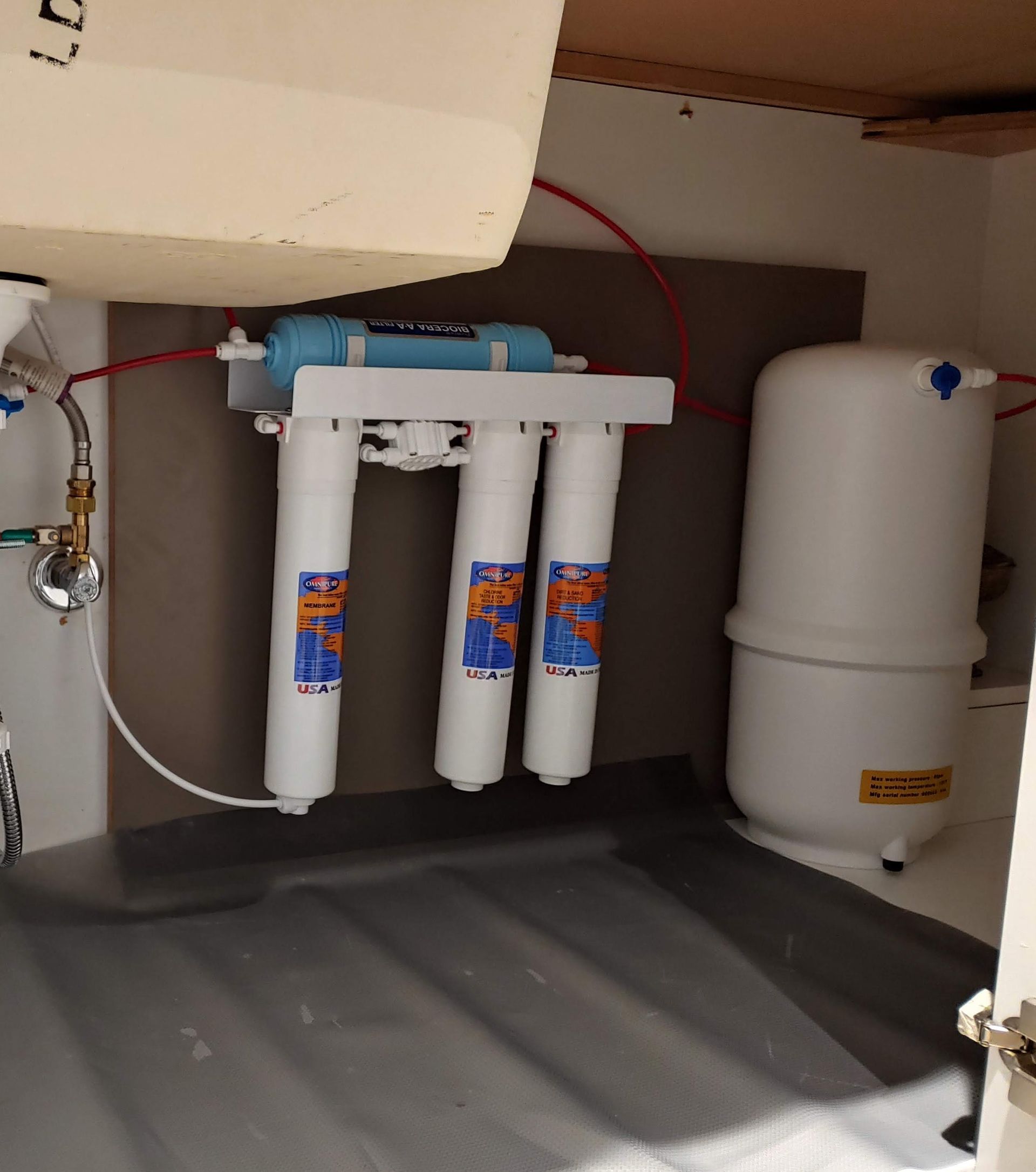 Platinum Series Omnipure Reverse Osmosis system with quick-change filters, Bio++ alkaline stage, and RO storage tank installed under a sink