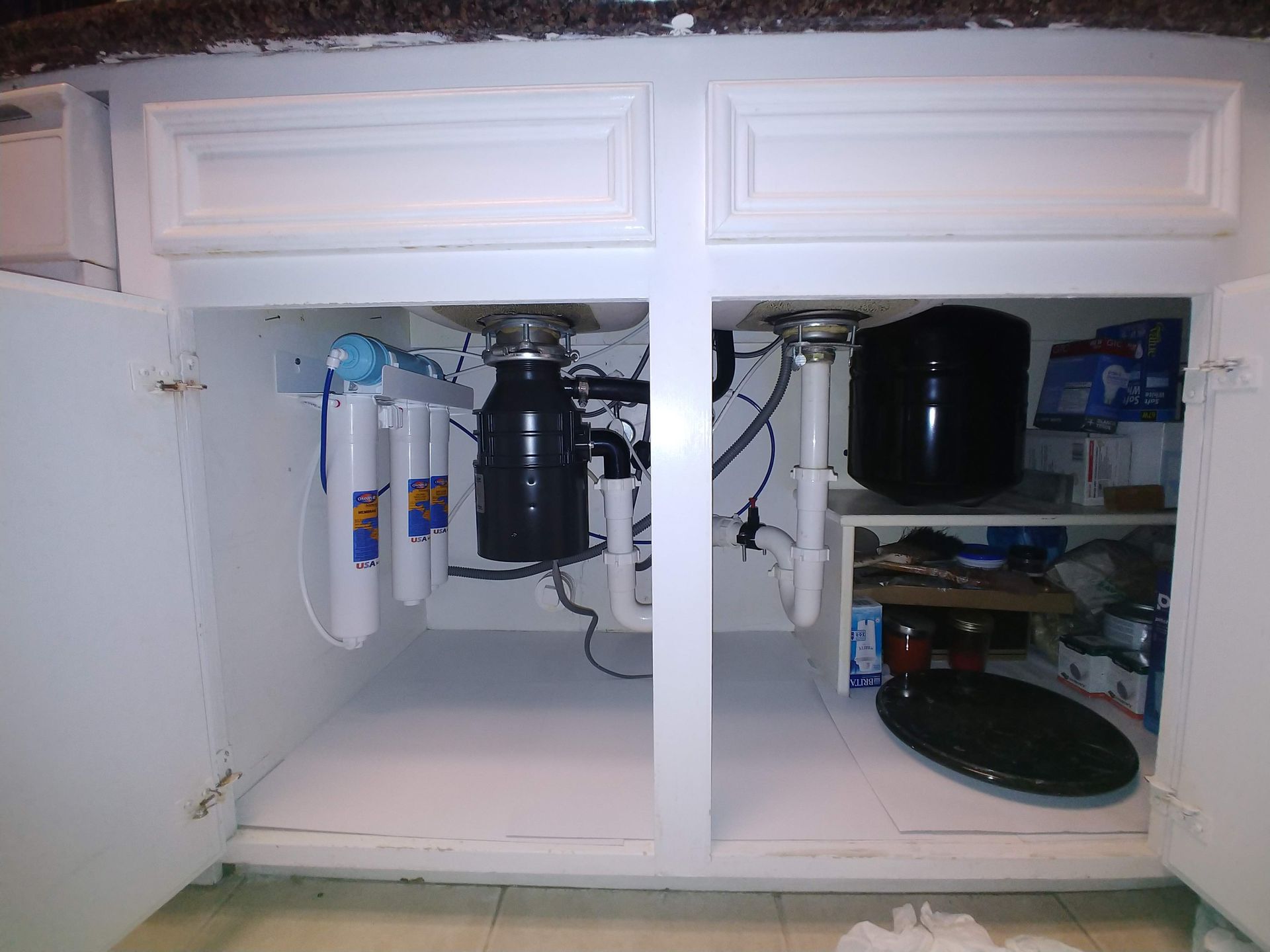 Under-sink Platinum Series Reverse Osmosis system with quick-change Omnipure inline filters, Bio++ alkaline filter, storage tank, and clean, organized tubing.