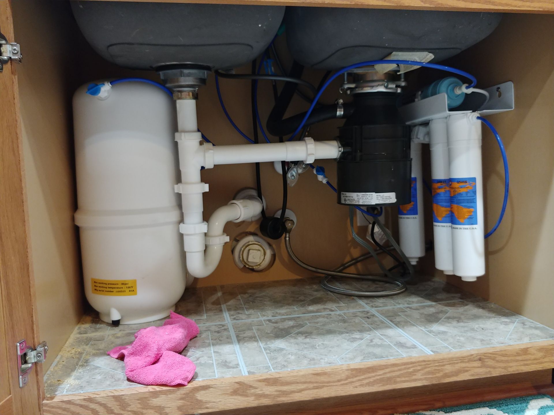 Under sink Platinum Series Omnipure reverse osmosis system with quick-change filters installed professionally with clean, organized tubing.