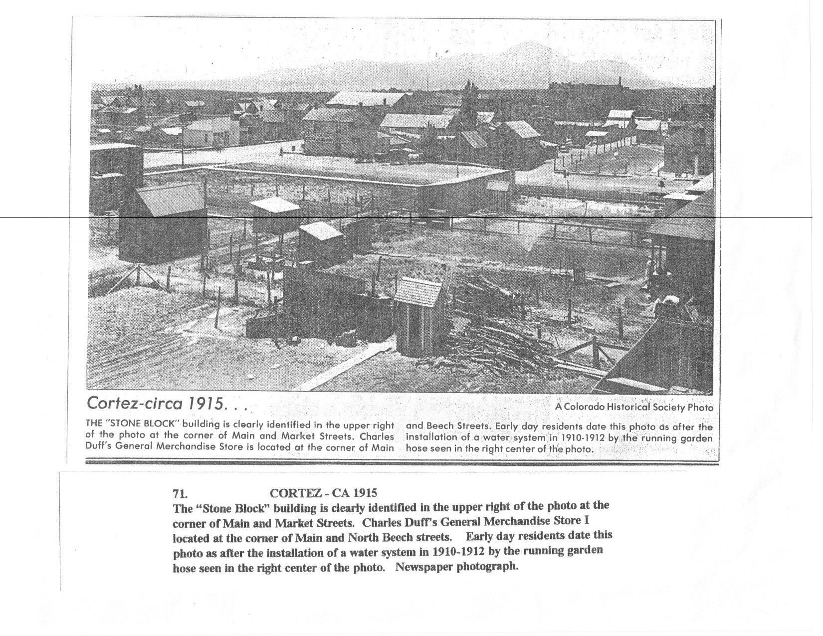 A black and white photo of a city with a mountain in the background.