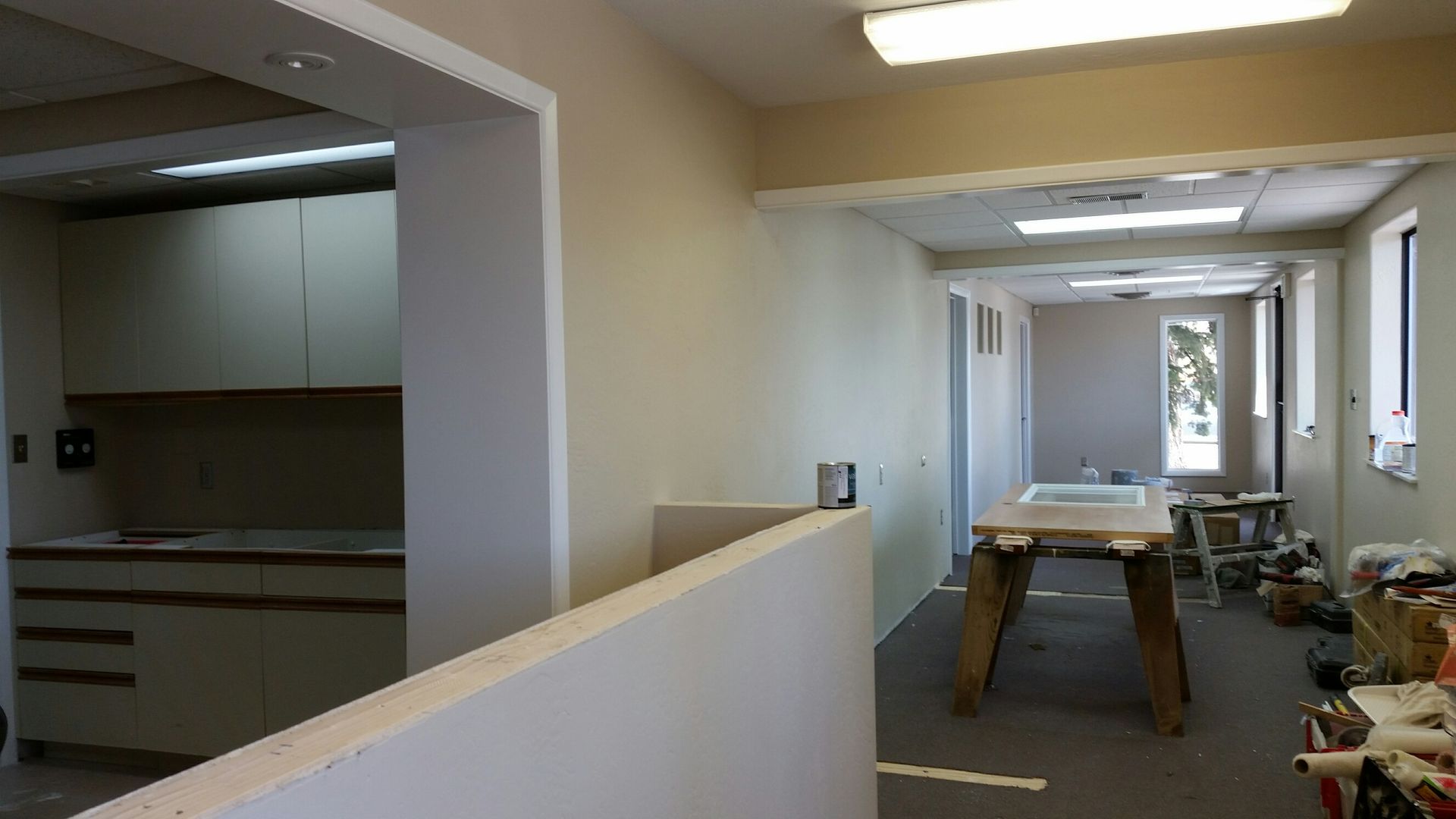 An empty room with a wooden table in the middle