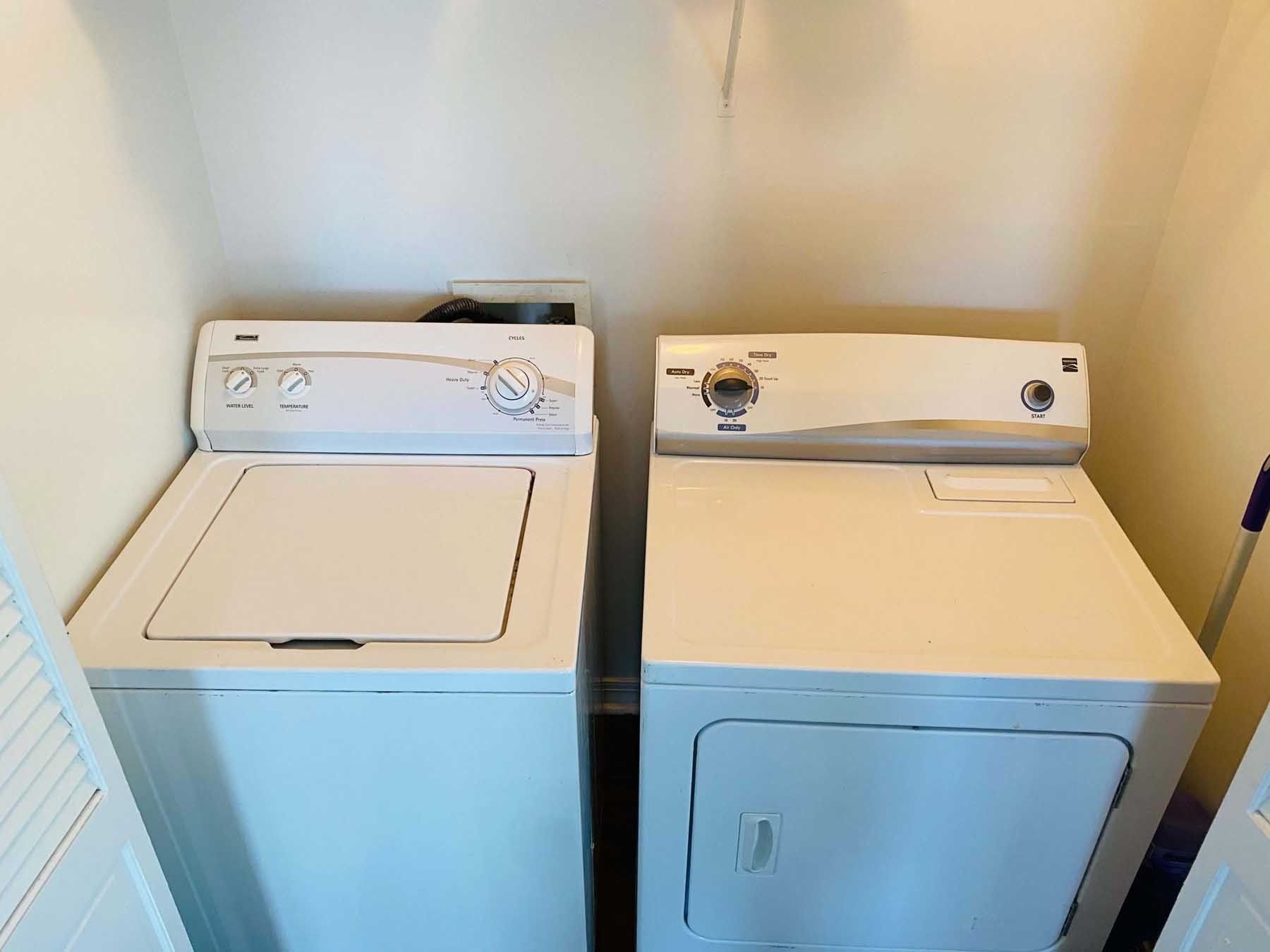 White washing machine and dryer in a laundry room, viewed from the front.