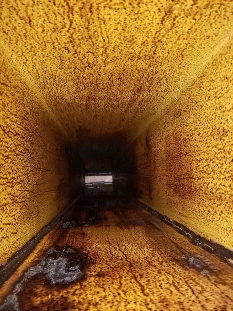 a close up of a dirty duct with a lot of stains on it .