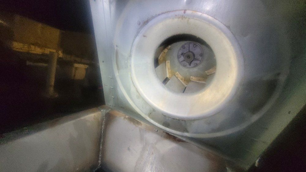 a close up of a fan in a room with a black background .