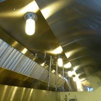 a kitchen with stainless steel appliances and a ceiling fan .