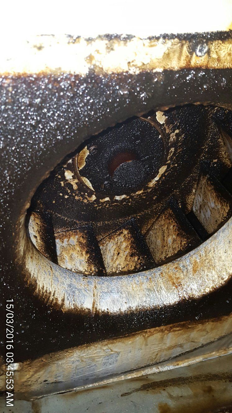 a close up of a dirty fan on a stove .