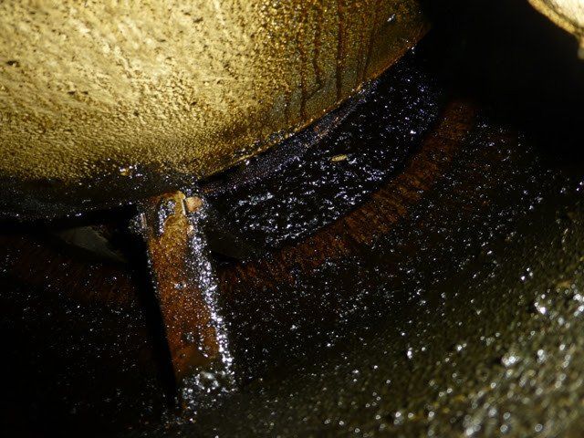 a close up of a dirty tank with water coming out of it .