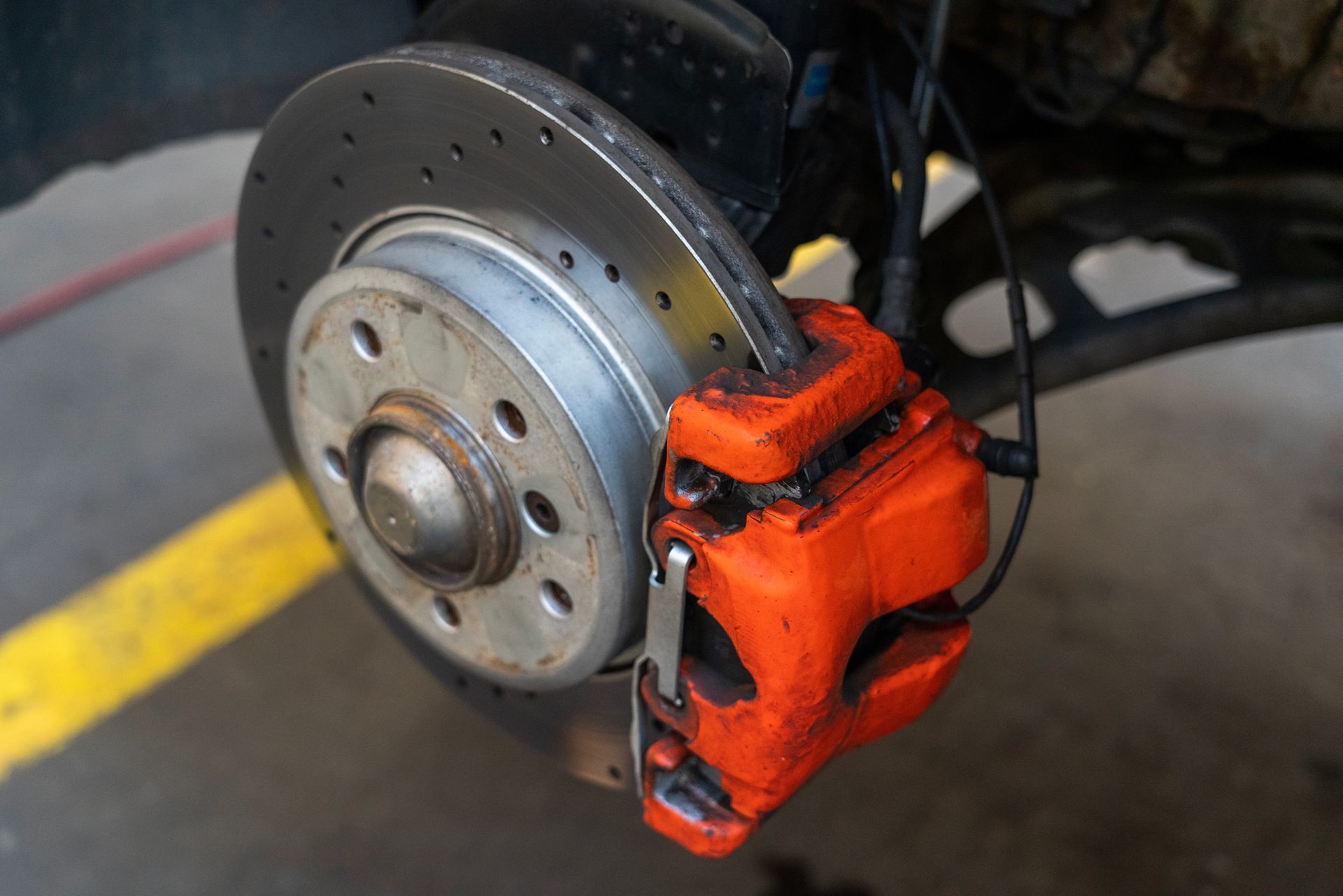A close up of a brake disc and brake caliper on a car.