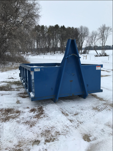 Blue dumpster at a snowy site. Blue dumpster at a snowy site.