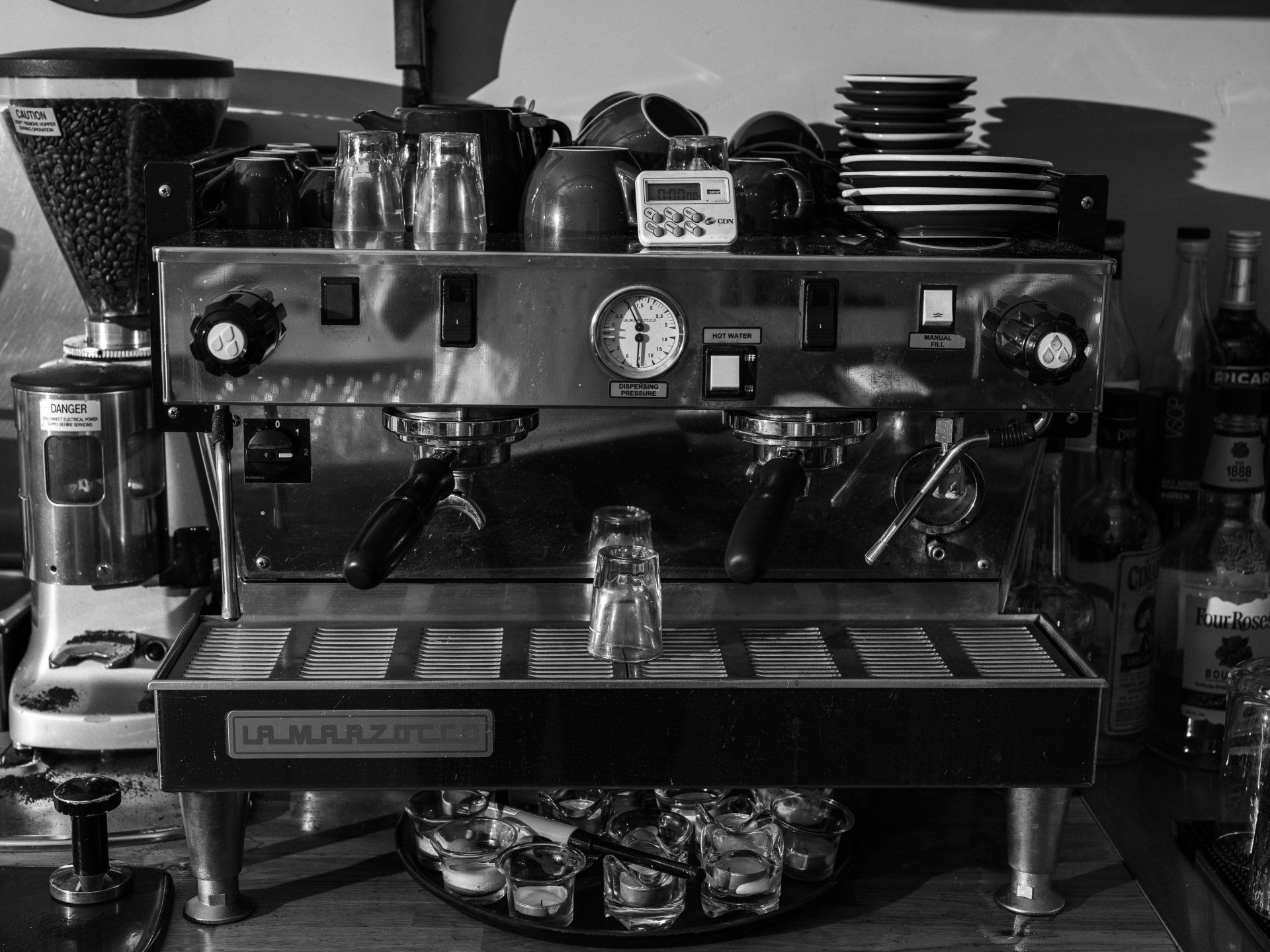 A black and white photo of a la marzocco coffee machine