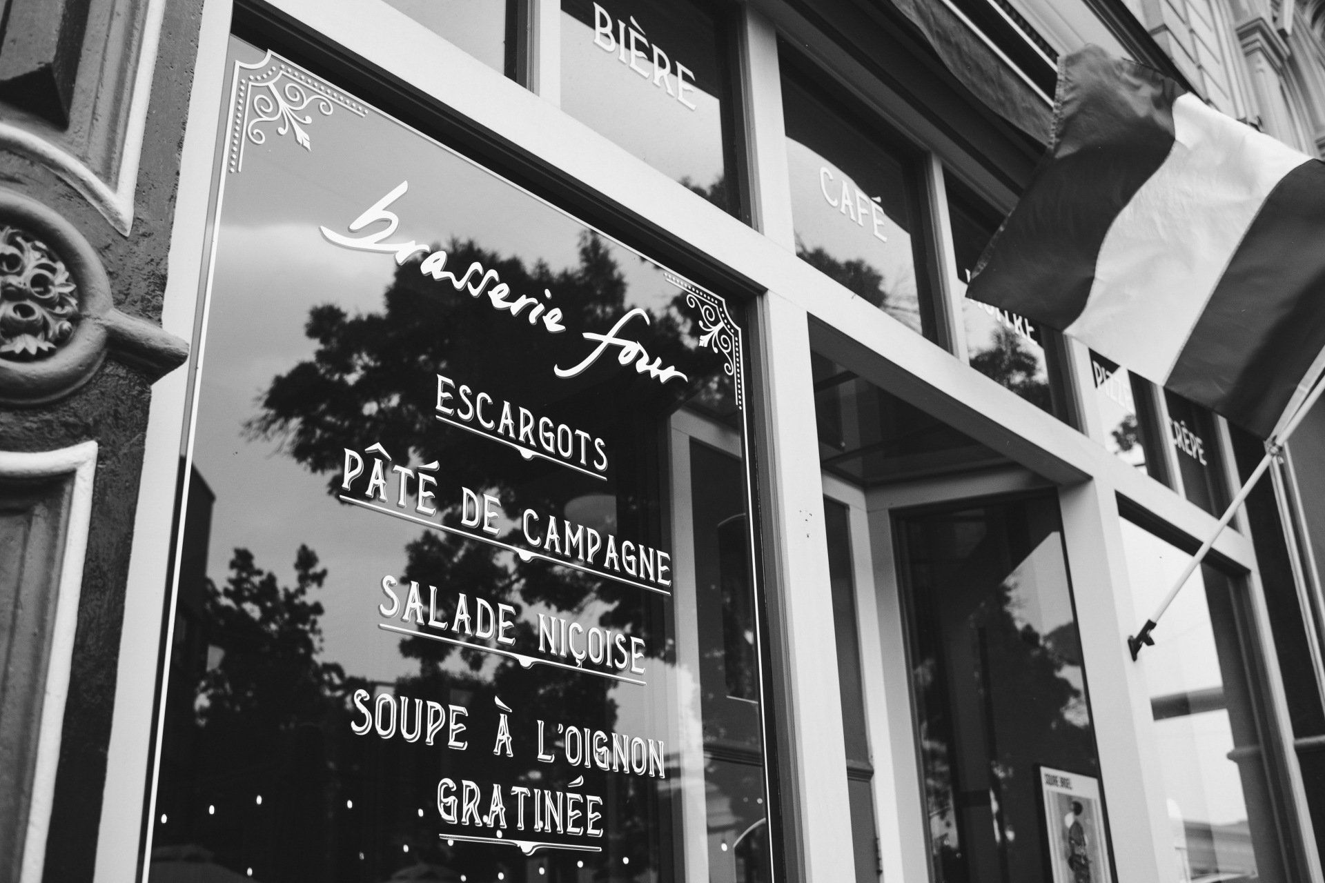 A black and white photo of a restaurant called brasserie four