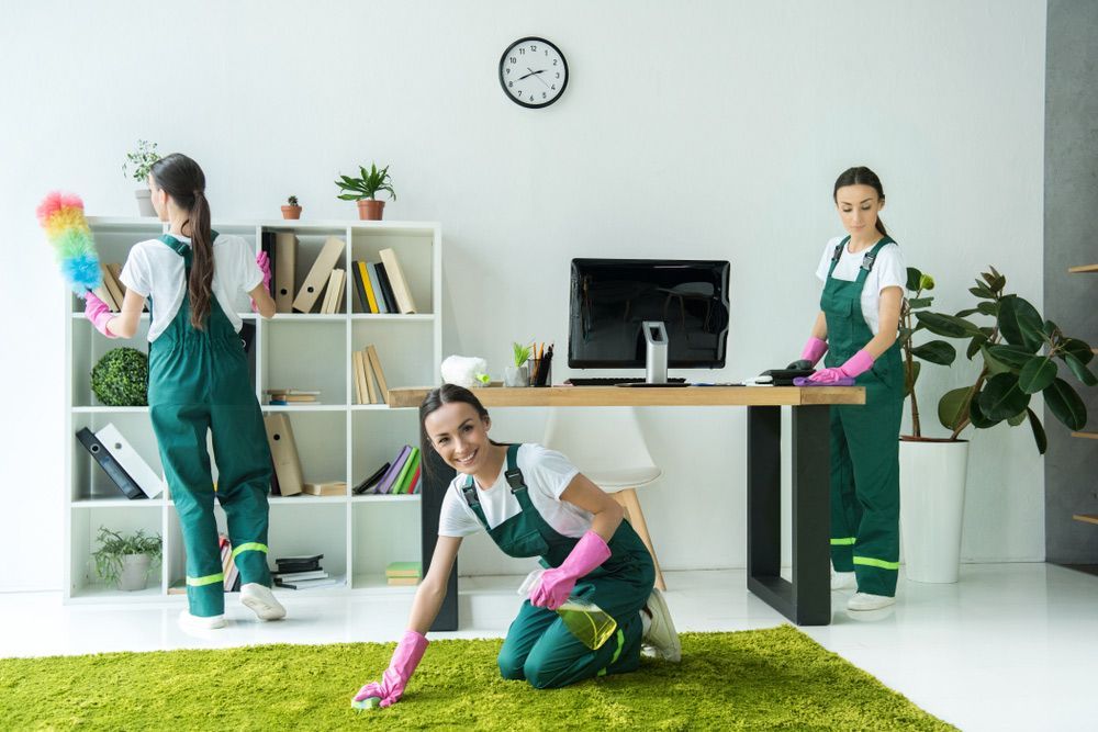 A Group of Women Are Cleaning a Room in An Office — Haydyn's Cleaning In Urraween, QLD