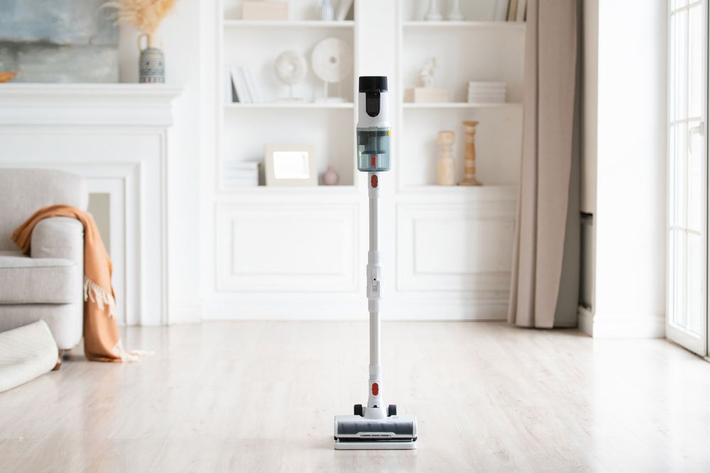 A Vacuum Cleaner Is Sitting on A Wooden Floor in A Living Room — Haydyn's Cleaning In Urangan, QLD