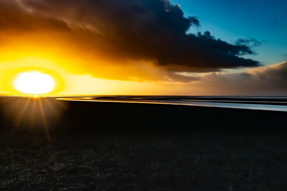 The Sun Is Setting Over a Body of Water — Haydyn's Cleaning In Dundowran, QLD