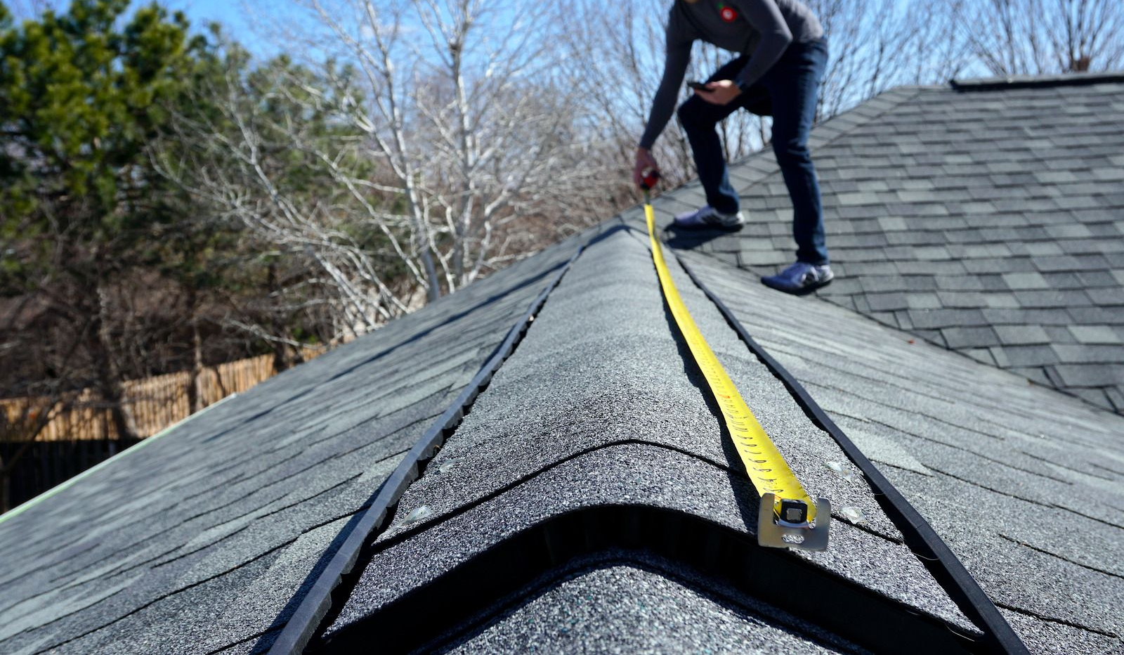 Woman smiles, pushing a cleaning cart down a well-lit hallway.